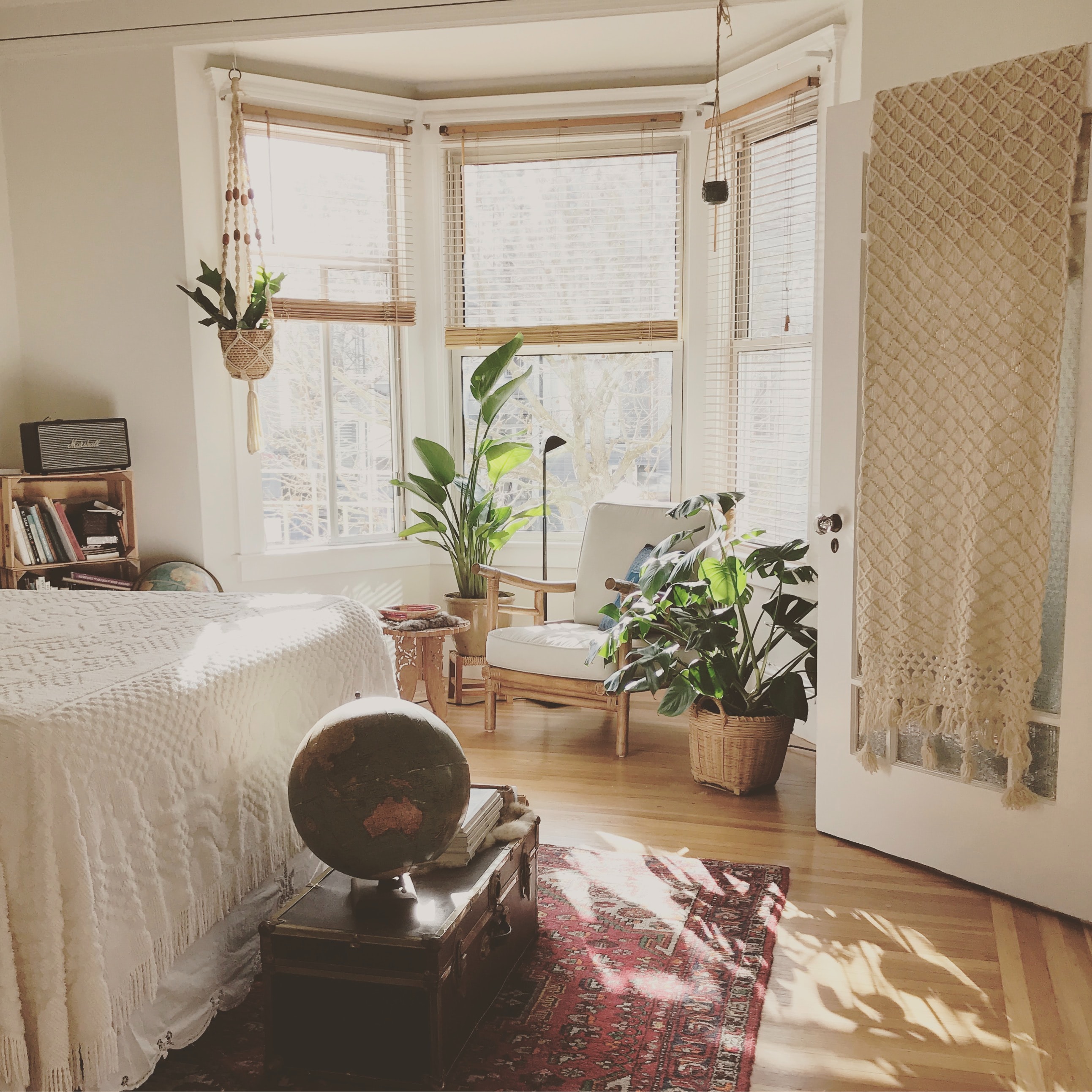 Sunlit bedroom with lots of plants